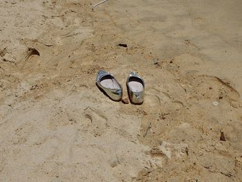 High angle view of shoes on sand