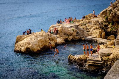 People on beach against sky