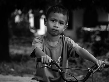 Portrait of boy with bicycle