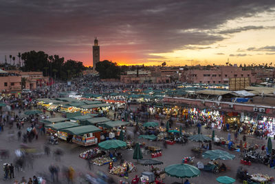 High angle view of people in city at sunset