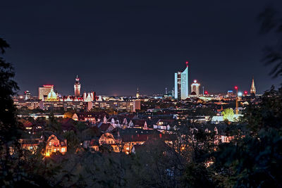 High angle view of illuminated buildings against sky at night