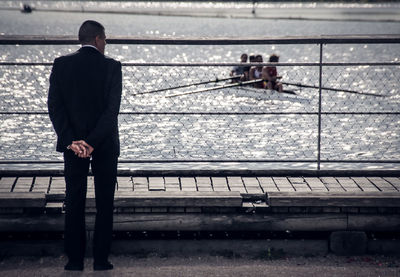 Businessman standing against sea