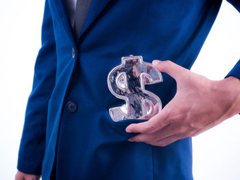 Midsection of man holding hands against white background