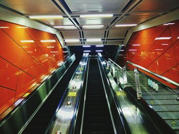 Low angle view of illuminated escalators at subway station