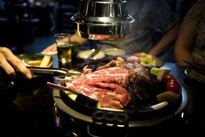 Close-up of person preparing food on table