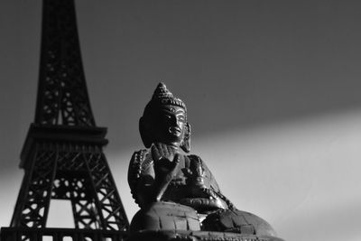 Low angle view of statue against temple against sky