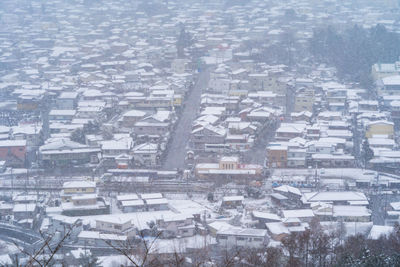 Aerial view of snow covered townscape