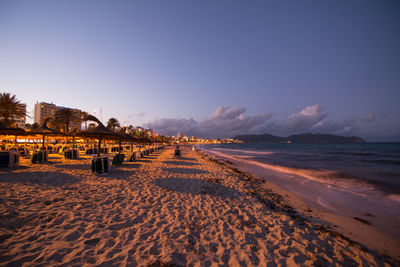 Scenic view of beach against sky during sunset