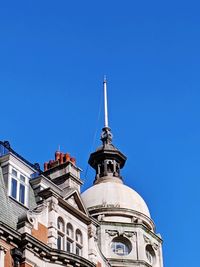 Low angle view of building against clear blue sky