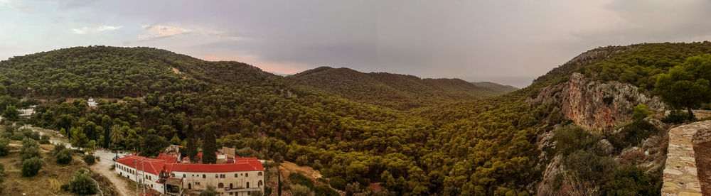 Panoramic view of trees and mountains against sky