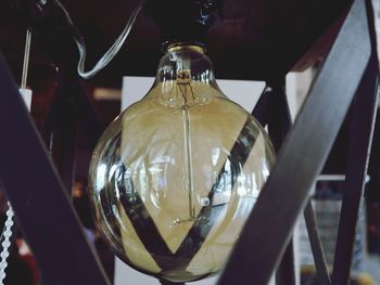 Close-up of light bulb hanging from ceiling