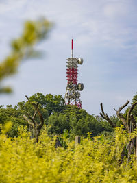 Low angle view of communications tower against sky