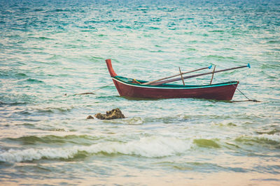 Boat moored on sea shore