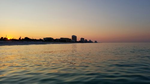 Scenic view of sea against clear sky during sunset