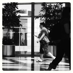 Full length of man walking on palm tree