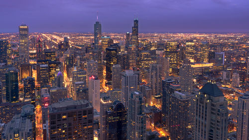 Aerial view of city lit up at night
