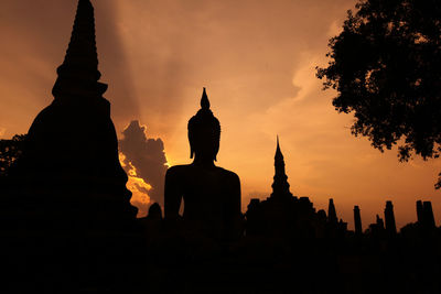 Silhouette of temple against sky during sunset