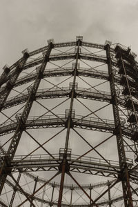 Low angle view of electricity pylon against sky