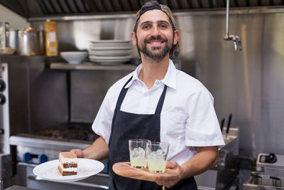 Portrait of a smiling young man in restaurant