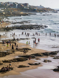 Moroccan beach with many people enjoying their summer holidays