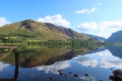 Scenic view of lake and mountains against sky