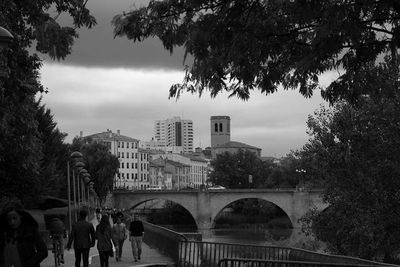 Buildings in city against cloudy sky