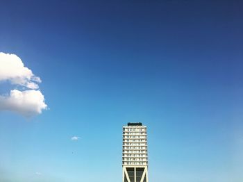 Low angle view of modern building against blue sky