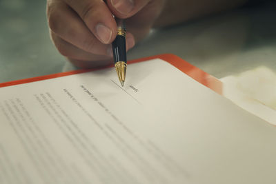 Close-up of hand holding book