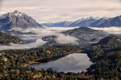 Scenic view of lake and mountains against sky during winter