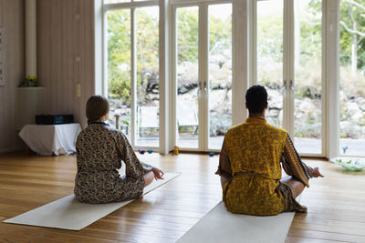 Rear view of people meditating