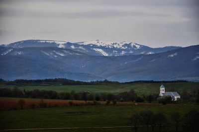 Scenic view of snowcapped mountains against sky