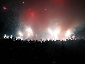 People watching firework display at night