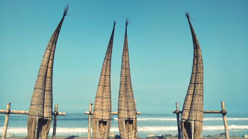 Sailboats in sea against clear blue sky