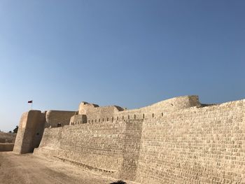 Low angle view of fort against clear sky