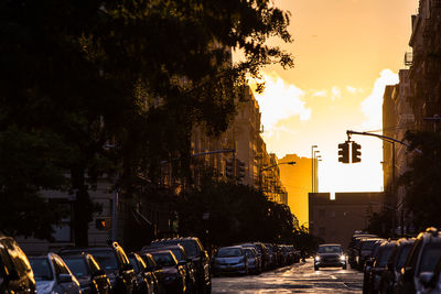 Bicycles in city against sky at sunset