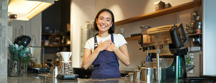 Portrait of young woman using mobile phone at home