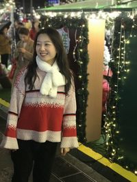 Portrait of a smiling young woman standing outdoors