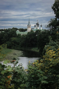 Scenic view of trees and buildings against sky