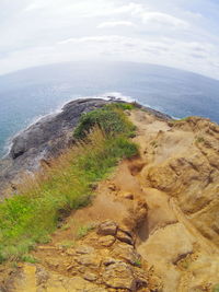 High angle view of rocks by sea against sky