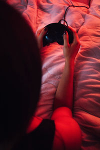 High angle view of woman resting on bed