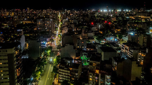 High angle view of illuminated buildings in city at night