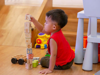 Boy playing with toy at home