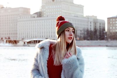 Portrait of beautiful young woman in city