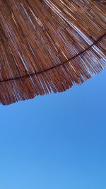 Low angle view of roof against clear blue sky