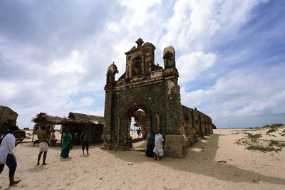 Tourists looking at cloudy sky