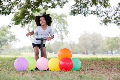 Full length of smiling girl on field