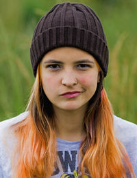 Portrait of young woman against plants