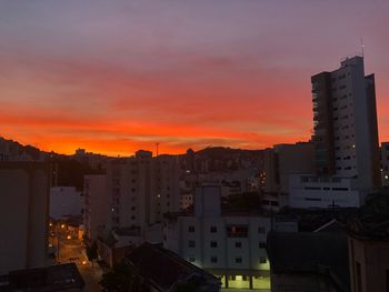 Exterior of illuminated buildings against sky at sunset