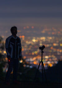 Rear view of silhouette man standing against sky during sunset