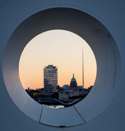 Custom house and buildings seen through circle shaped window